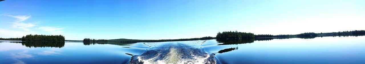 Panoramic view of lake against clear blue sky