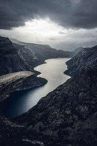 Scenic view of fjord and mountains against sky