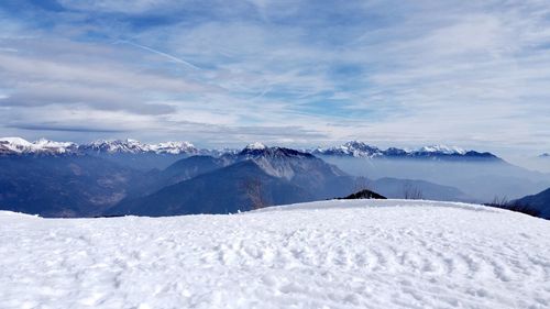 Scenic view of snow covered mountains against sky