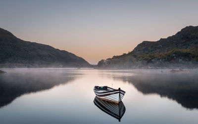 Boat in lake against sky