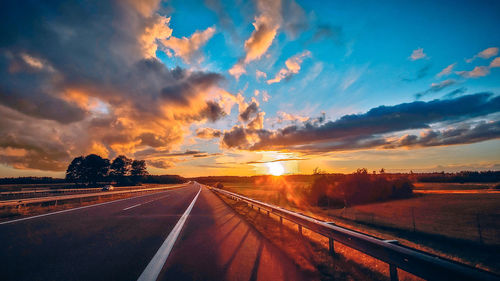 Orange sunset with clouds. view from highway