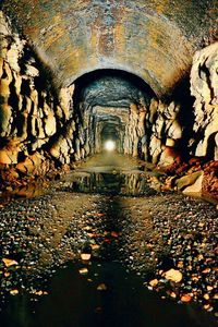 Illuminated tunnel at night