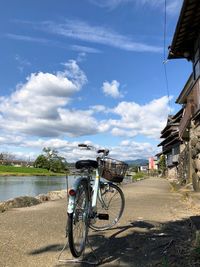 Bicycle on road against sky in city