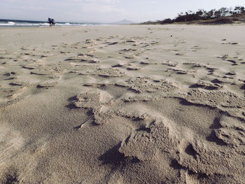 People walking on shore at beach