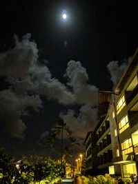Low angle view of illuminated city against sky at night