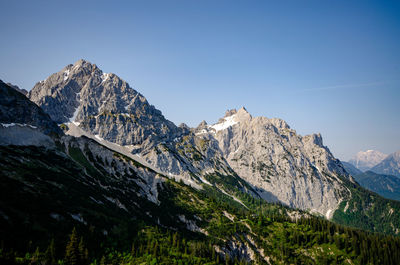 Scenic view of mountains against clear blue sky