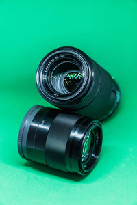Close-up of camera lens on green background
