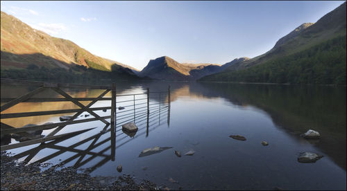 Scenic view of lake and mountains against sky