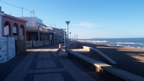 View of beach against clear blue sky