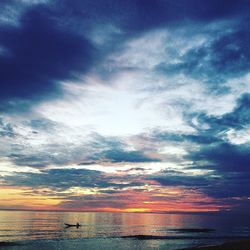 Scenic view of sea against cloudy sky