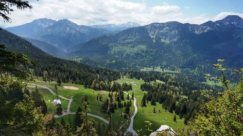 Scenic view of trees and mountains against sky