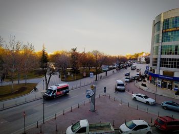 Traffic on road in city against sky