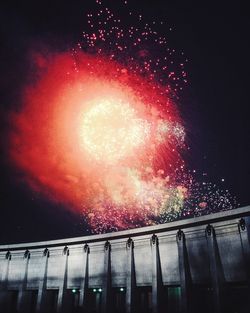 Low angle view of firework display at night