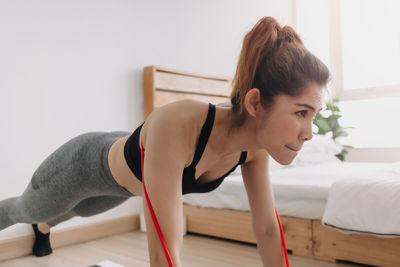 Beautiful woman working out at home