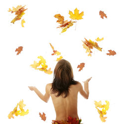 Rear view of woman with leaves against white background