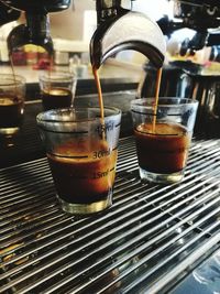 Close-up of coffee machine filling glass 