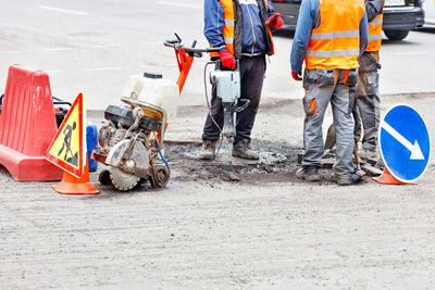 Low section of men working at construction site