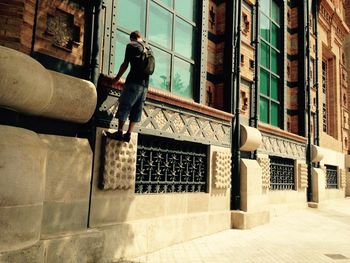 Full length of man climbing building