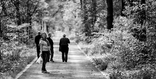 Rear view of people walking on footpath