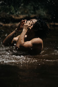 Rear view of a man in water