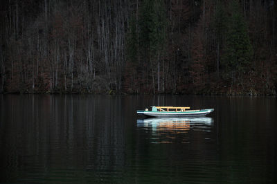 Sailboat sailing on lake in forest, while visiting königss of germany.