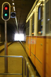 Train at railroad station platform at night