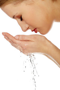 Close-up of woman hand over white background
