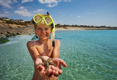 Portrait of young woman swimming in sea