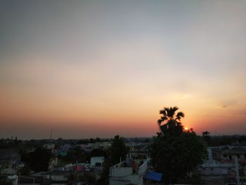 High angle view of townscape against orange sky