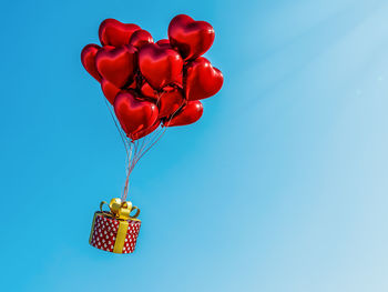 Close-up of red balloons against blue background