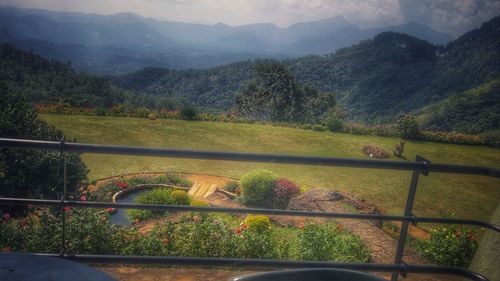 High angle view of sheep on landscape against mountains