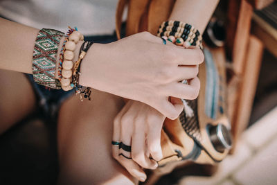 Female hands with boho accessories bracelets made of colored beads