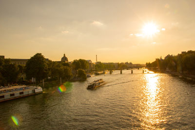 Scenic view of river against sky at sunset