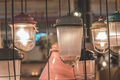 Close-up of glasses hanging at night