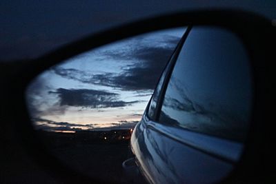 Reflection of sky on side-view mirror