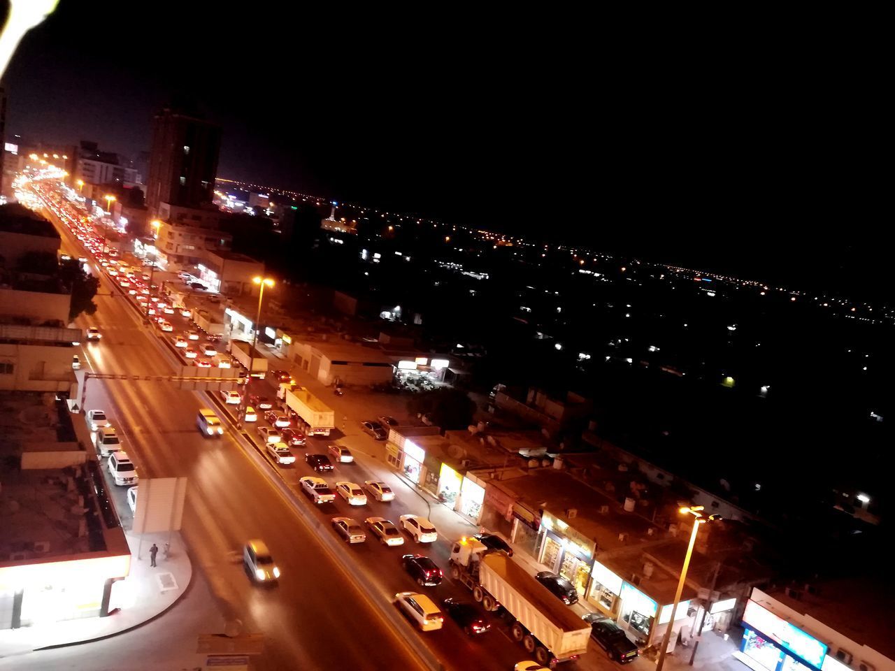 HIGH ANGLE VIEW OF TRAFFIC ON CITY STREET AT NIGHT