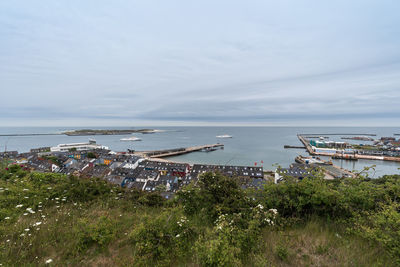 High angle view of sea by buildings against sky