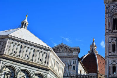 Low angle view of buildings against blue sky