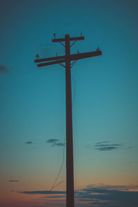 Low angle view of silhouette cross against sky during sunset