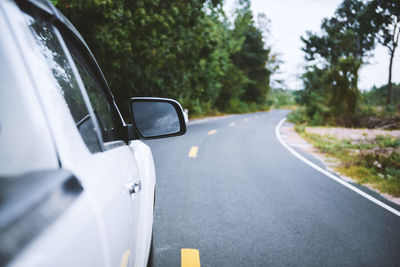 Close-up of car on road