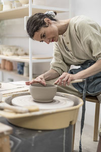 Side view of man working at workshop