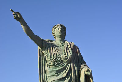 Low angle view of statue against blue sky