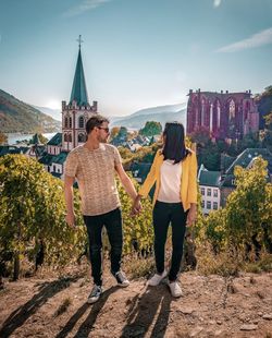 Couple standing against buildings 