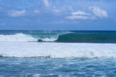 Blue closing surfing wave at popular surf beach balangan in bali island, indonesia
