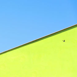 Low angle view of building against clear blue sky