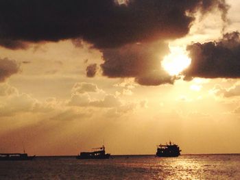 Boat in sea at sunset