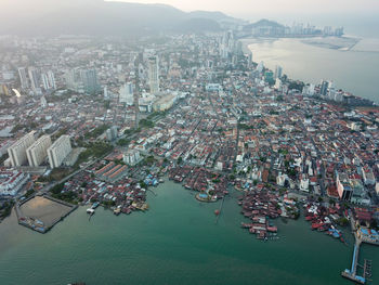 High angle view of buildings and sea in city