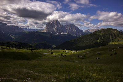 Scenic view of field and mountains against sky
