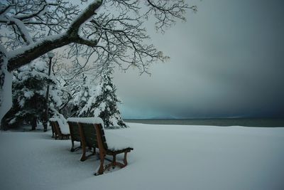 Bench on the lakeshore of biwako lake at snowy morning