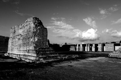 Old ruins on rock formation against sky